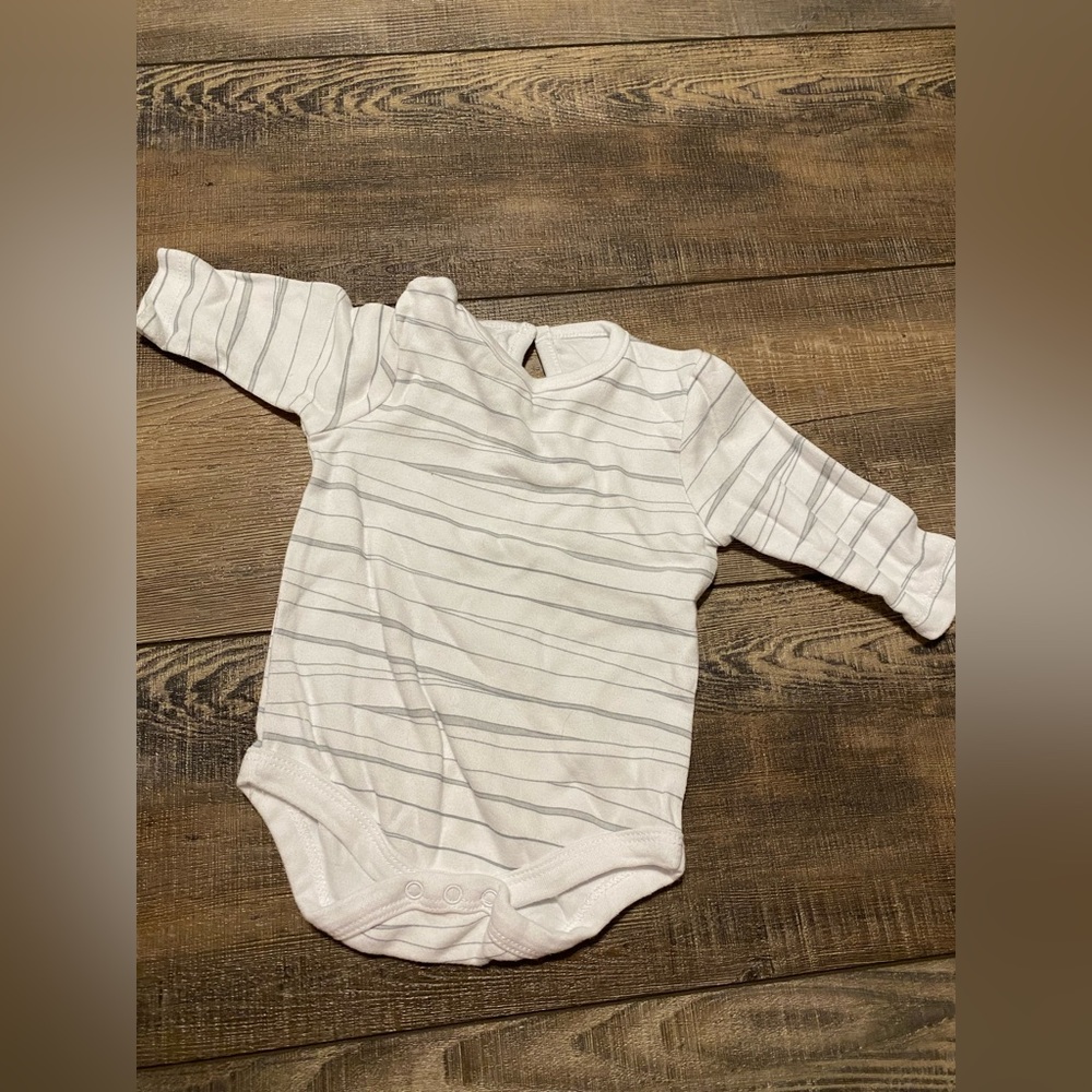 A plain white long sleeve onesie with grey stripes.